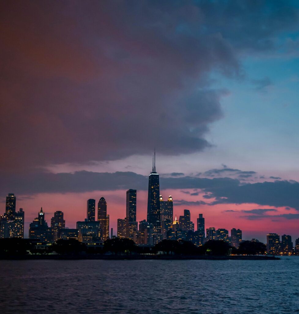 Capture the beauty of Chicago's skyline at dusk, with vibrant skies and illuminated buildings.